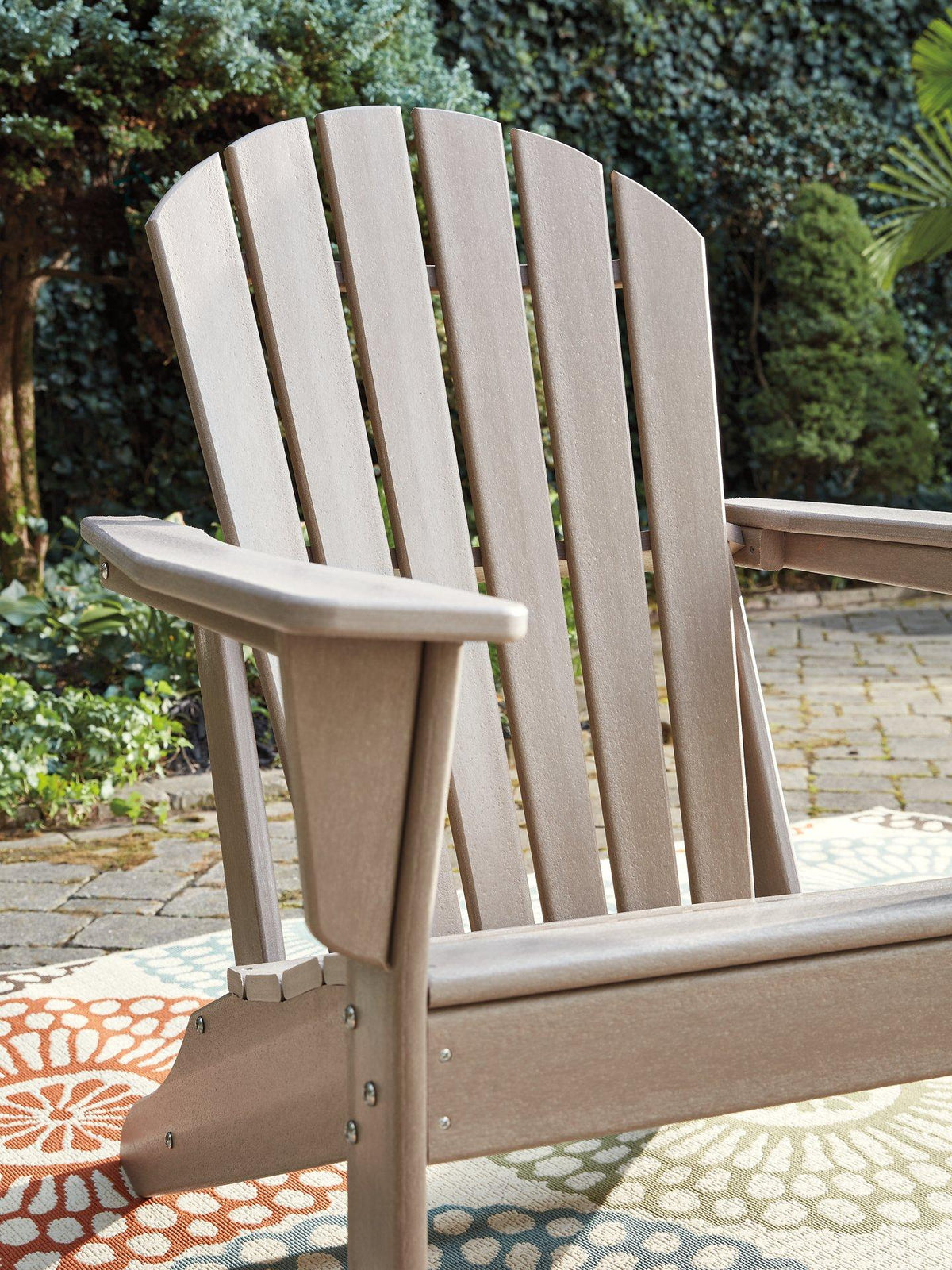 Outdoor table set by Ashley Furniture featuring a glass-top table and cushioned chairs from the Sundown Treasure collection.
