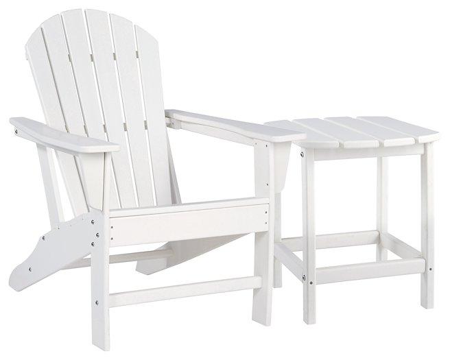 Outdoor table set from Ashley Furniture featuring a glass-top table and matching chairs in a sunny outdoor setting.