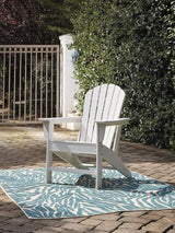 Outdoor table set by Ashley Furniture with a wooden table and matching chairs, perfect for outdoor dining and relaxation.