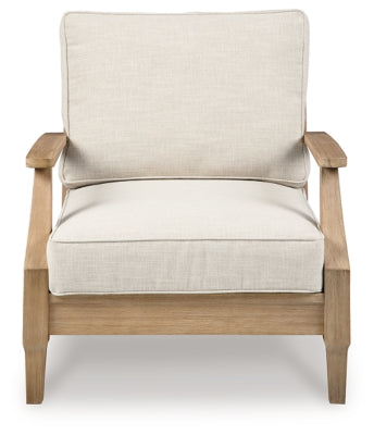 Ashley Furniture Carter Hall outdoor table set with a rectangular table and six matching chairs in a garden setting.