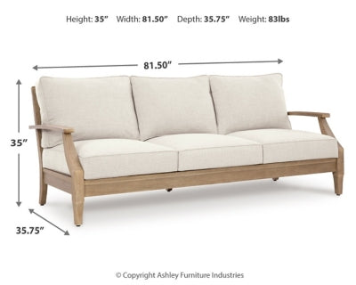 Ashley Furniture Carter Hall outdoor table set with a large rectangular table and matching chairs in a backyard setting.