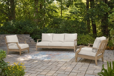 Ashley Furniture Carter Hall outdoor table set with a dining table and matching chairs in a stylish outdoor patio setting.