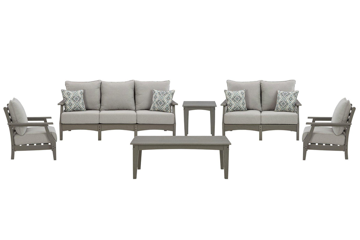 Ashley Furniture Visola outdoor sofa and loveseat set with matching outdoor table, designed for comfortable outdoor lounging.