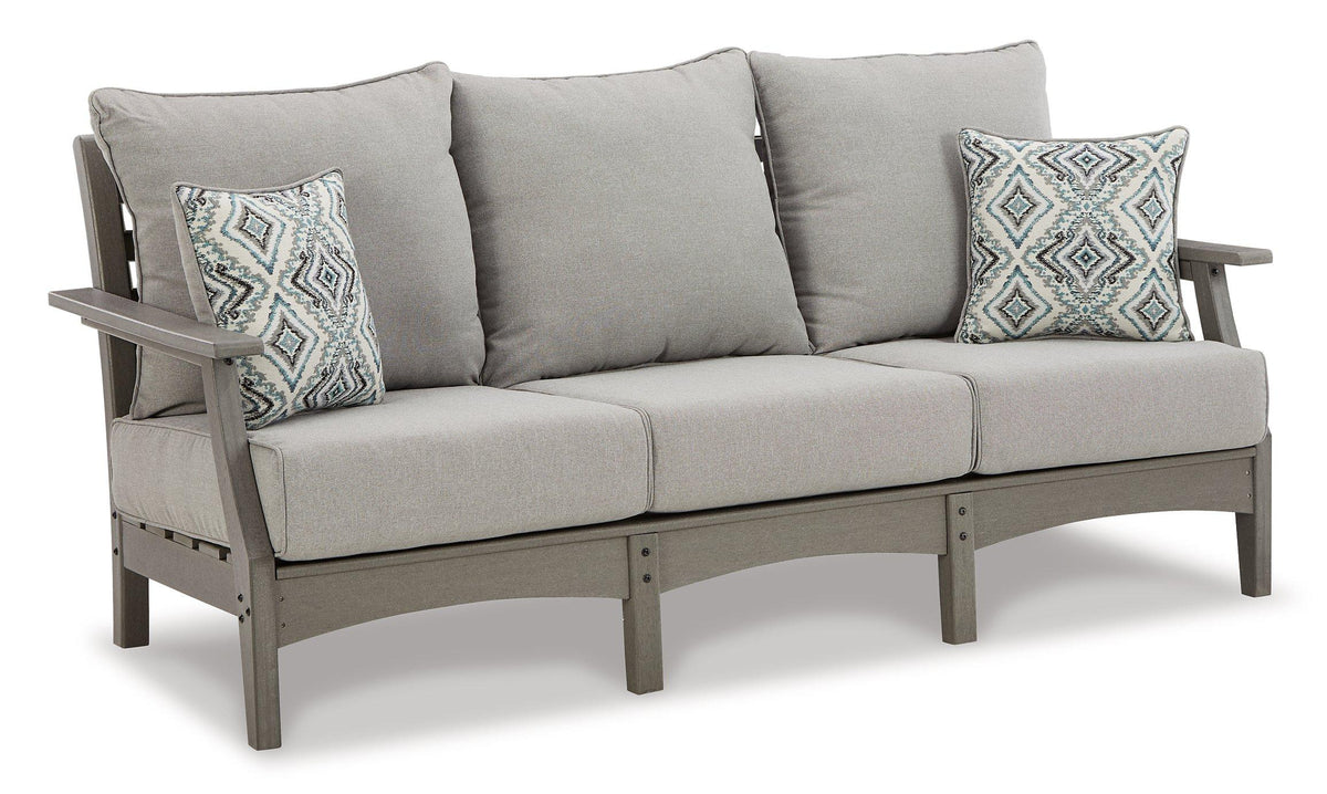 Ashley Furniture Visola outdoor sofa and loveseat set with a matching outdoor table, featuring cushioned seating and weather-resistant design.