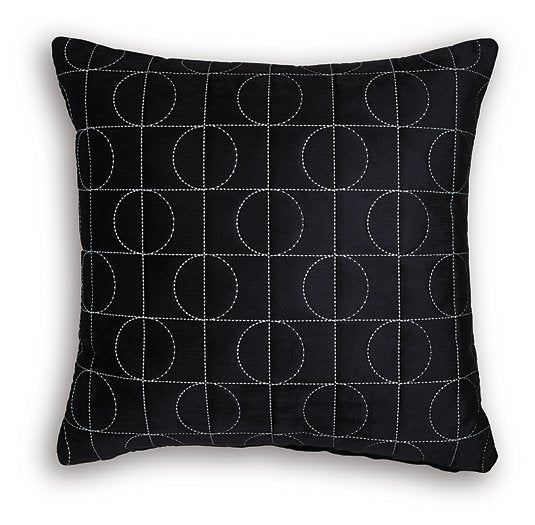 Set of four Ashley Furniture Kydner decorative pillows with patterned fabric and plush texture, arranged on a neutral-colored sofa.