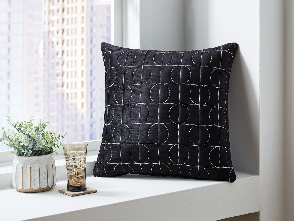 Set of four Ashley Furniture Kydner pillows with textured fabric in neutral tones, perfect for living room or bedroom decor.
