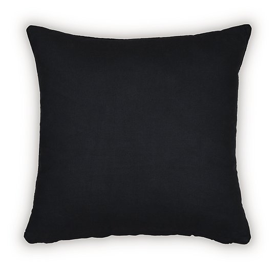 Set of four Ashley Furniture Kydner pillows with decorative patterns and neutral tones, arranged on a cozy sofa.