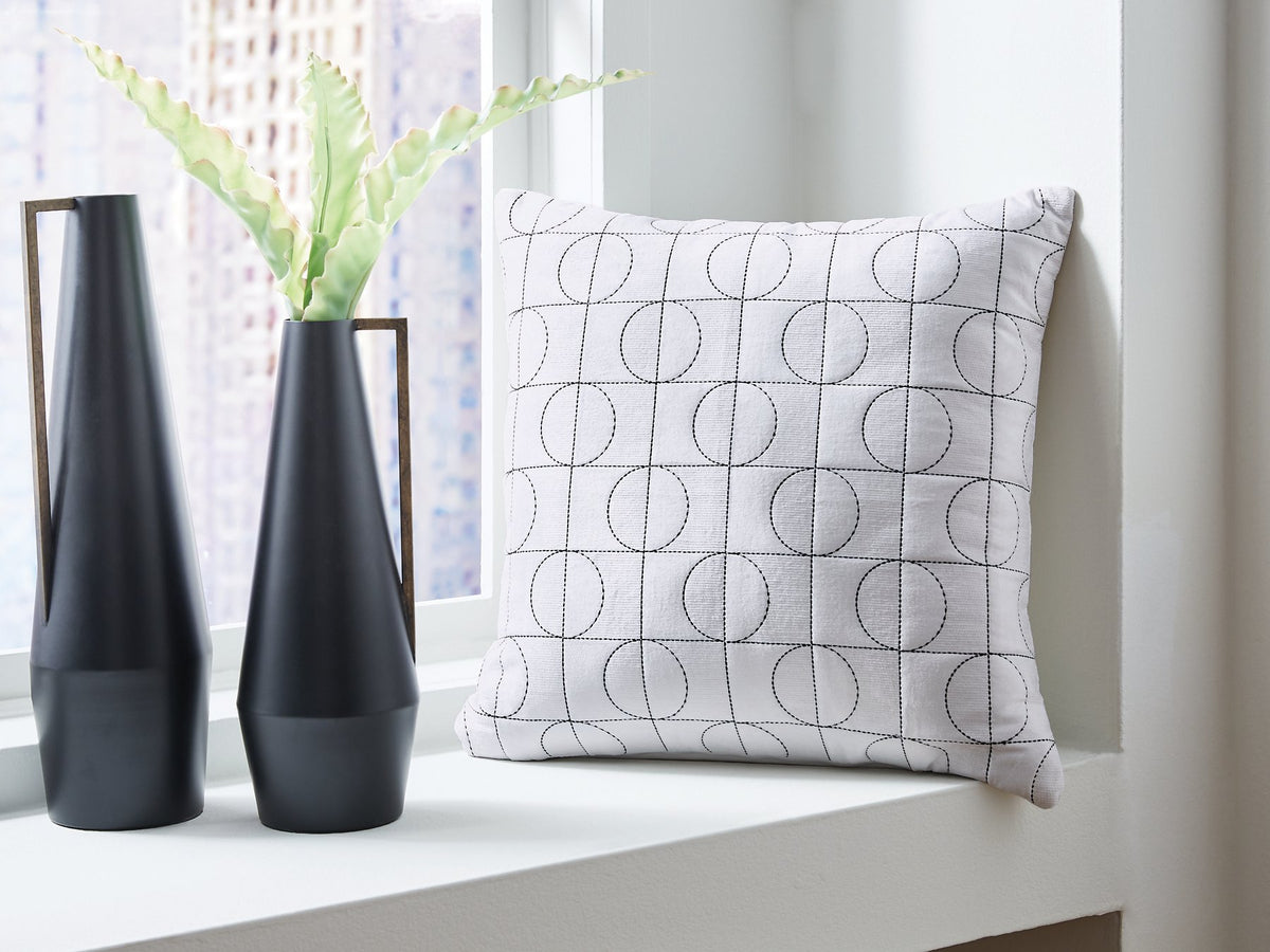 Set of four Ashley Furniture Kydner decorative pillows with neutral fabric covers, perfect for enhancing living room décor.