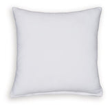 Set of four Ashley Furniture Kydner pillows featuring neutral fabric and decorative stitching, arranged on a cozy sofa.