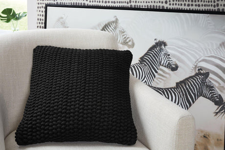 Set of four Ashley Furniture Renemore pillows with soft fabric covers, perfect for sofa or bed decoration.