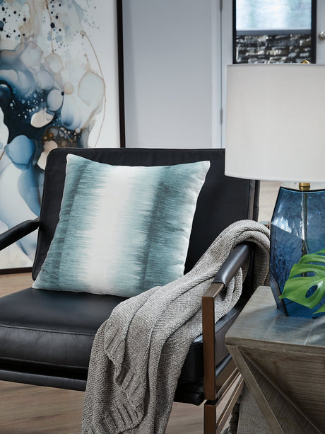 Ashley Furniture Elonwich Pillow featuring a soft, decorative cushion with a textured design and neutral tones.