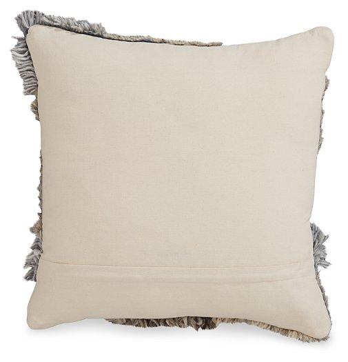 Set of four Ashley Furniture Gibbend pillows with textured fabric in neutral tones, arranged on a cozy sofa.