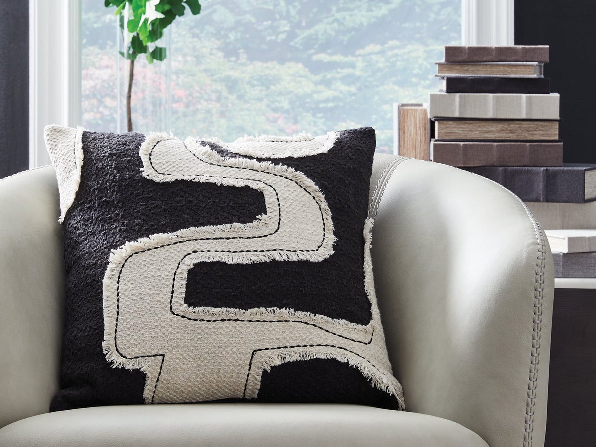 Set of four Ashley Furniture Veerbank decorative pillows with geometric patterns on neutral fabric, suitable for sofa or bed decor.