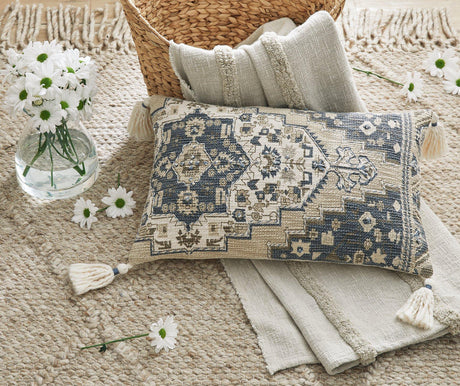Set of four Ashley Furniture Winbury pillows with textured fabric and decorative patterns, ideal for bedroom or living room decor.