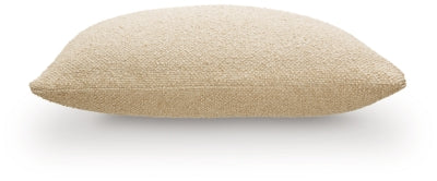 Set of four Ashley Furniture Macsen pillows with decorative covers, featuring textured fabric and neutral tones, arranged on a sofa.