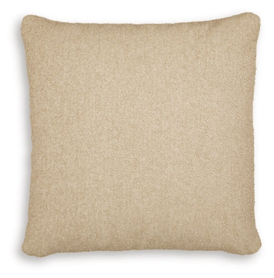Set of four Ashley Furniture Macsen pillows with decorative fabric covers, arranged in a cozy living room setting.
