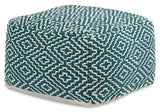 Ashley Furniture Brynnsen Pouf, soft fabric upholstery and round shape, used as a footrest or accent piece in living room decor.
