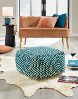 Ashley Furniture Brynnsen Pouf, soft fabric upholstery, modern design, neutral color, compact seating or footrest in a stylish living space.