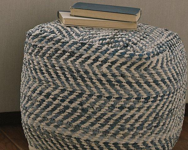 Chevron pouf by Ashley Furniture featuring a stylish fabric cover and plush cushioning for versatile interior decor.
