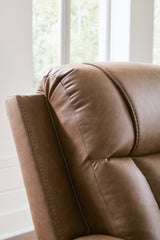 Ashley Furniture Mackmenville recliner with plush upholstery and padded armrests, shown in a close-up detail shot.