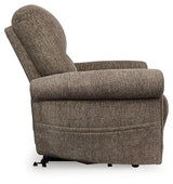 Ashley Furniture Aureta Power Lift Recliner in plush fabric with cushioned armrests and a lifting mechanism for easy standing.