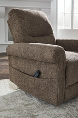 Ashley Furniture Aureta Power Lift Recliner in neutral fabric, featuring plush cushioning and a sturdy wooden base.