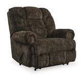 Ashley Furniture Movie Man recliner in plush fabric with padded armrests and a reclining mechanism for comfortable seating.
