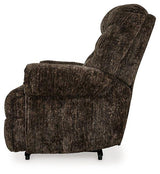 Ashley Furniture Movie Man Recliner showing plush fabric upholstery and padded armrests for comfortable seating.