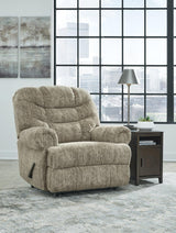 Ashley Furniture Movie Man recliner, plush brown upholstered recliner with padded armrests and a comfortable design.