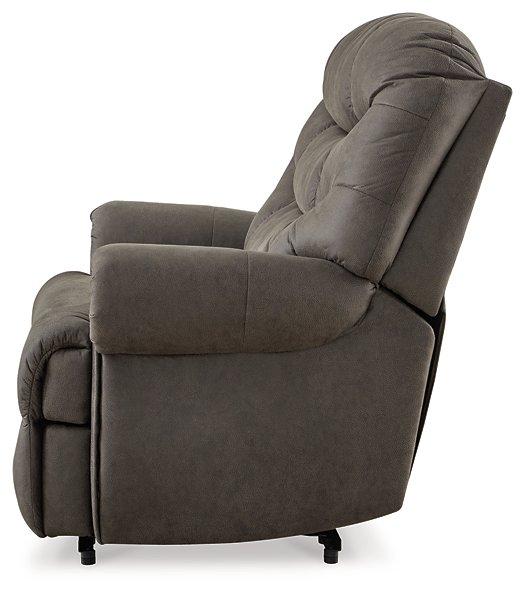 Ashley Furniture Camera Time Recliner showing plush beige upholstery and padded armrests in a modern living room setting.