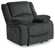 Comfortable Ashley Furniture Draycoll recliner with plush upholstery and padded armrests, perfect for relaxing in the living room.