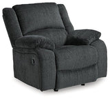 Comfortable Ashley Furniture Draycoll recliner with plush upholstery and padded armrests, perfect for relaxing in the living room.