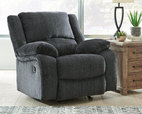 Comfortable Ashley Furniture Draycoll recliner with plush upholstery and padded armrests, ideal for relaxing in a modern living room.