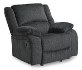 Ashley Furniture Draycoll recliner showing plush fabric upholstery and padded armrests in a cozy living room setting.