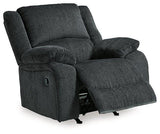 Ashley Furniture Draycoll recliner in brown leather with plush cushioning and wide armrests, perfect for relaxing.