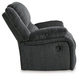 Ashley Furniture Draycoll recliner, plush fabric, padded armrests, and reclining mechanism visible in this comfortable seating image.