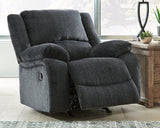 Ashley Furniture Draycoll recliner showing plush fabric, padded armrests, and a comfortable recline in a modern living room setting.