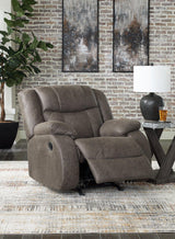 Comfortable Ashley Furniture First Base Recliner with plush upholstery and padded armrests, ideal for relaxing in the living room.