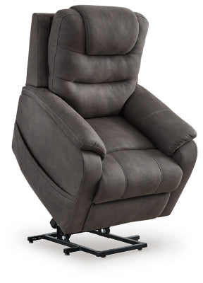 Ashley Furniture Snowfield Power Lift Recliner in beige fabric, showing the reclined position with padded armrests and plush cushioning.