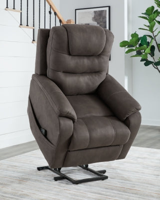 Ashley Furniture Snowfield Power Lift Recliner in beige fabric with plush cushioning and a built-in lift mechanism.