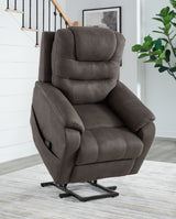 Ashley Furniture Snowfield Power Lift Recliner in beige fabric with plush cushioning and a built-in lift mechanism.