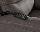 Ashley Furniture Snowfield Power Lift Recliner in beige fabric with plush cushioning and a built-in lift mechanism.