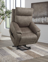 Ashley Crestmeade Power Lift Recliner in beige fabric with padded armrests and plush cushioning, designed for comfort and support.