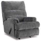 Ashley Furniture Man Fort Recliner showing plush fabric upholstery and ergonomic design in a cozy living room setting.