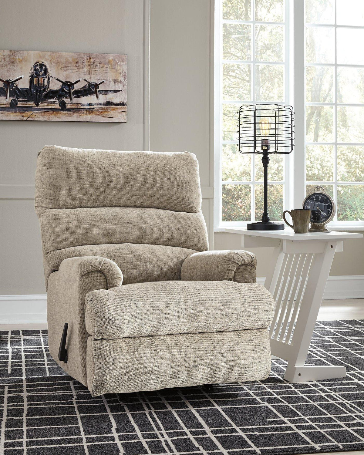 Ashley Furniture Man Fort Recliner featuring plush fabric and cushioned armrests, perfect for relaxing in style.