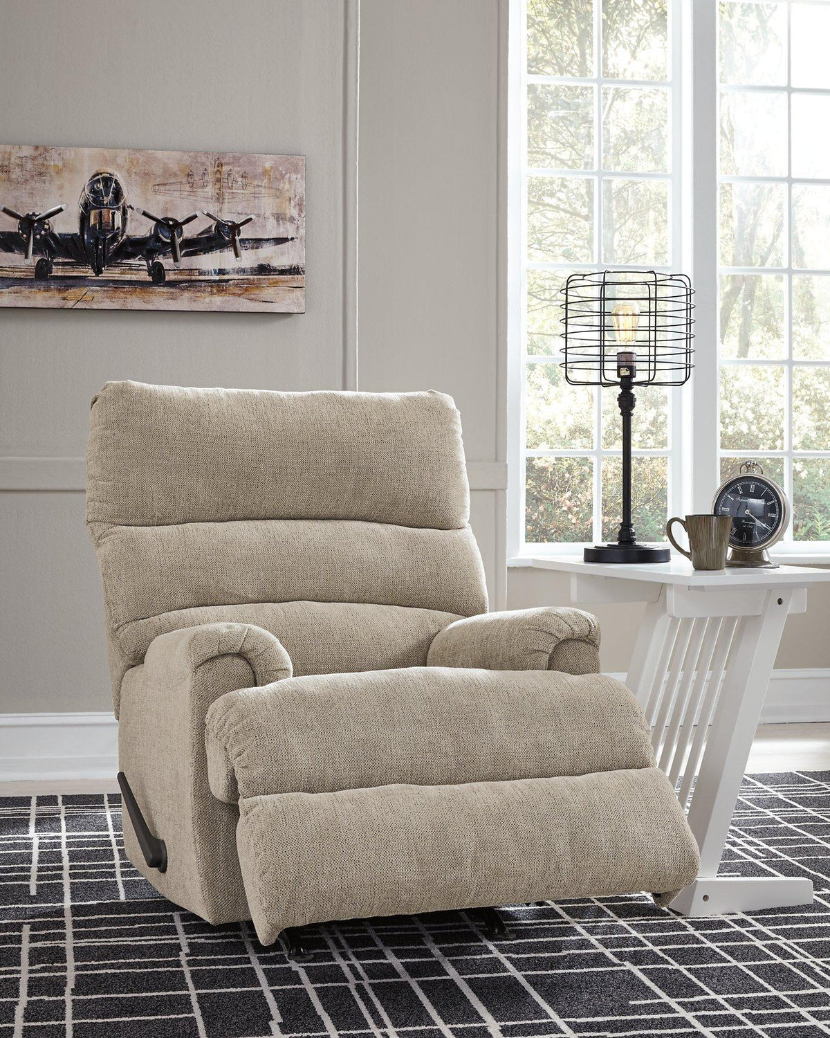 Ashley Furniture Man Fort Recliner showing a plush, brown recliner chair with padded armrests and comfortable cushioning.