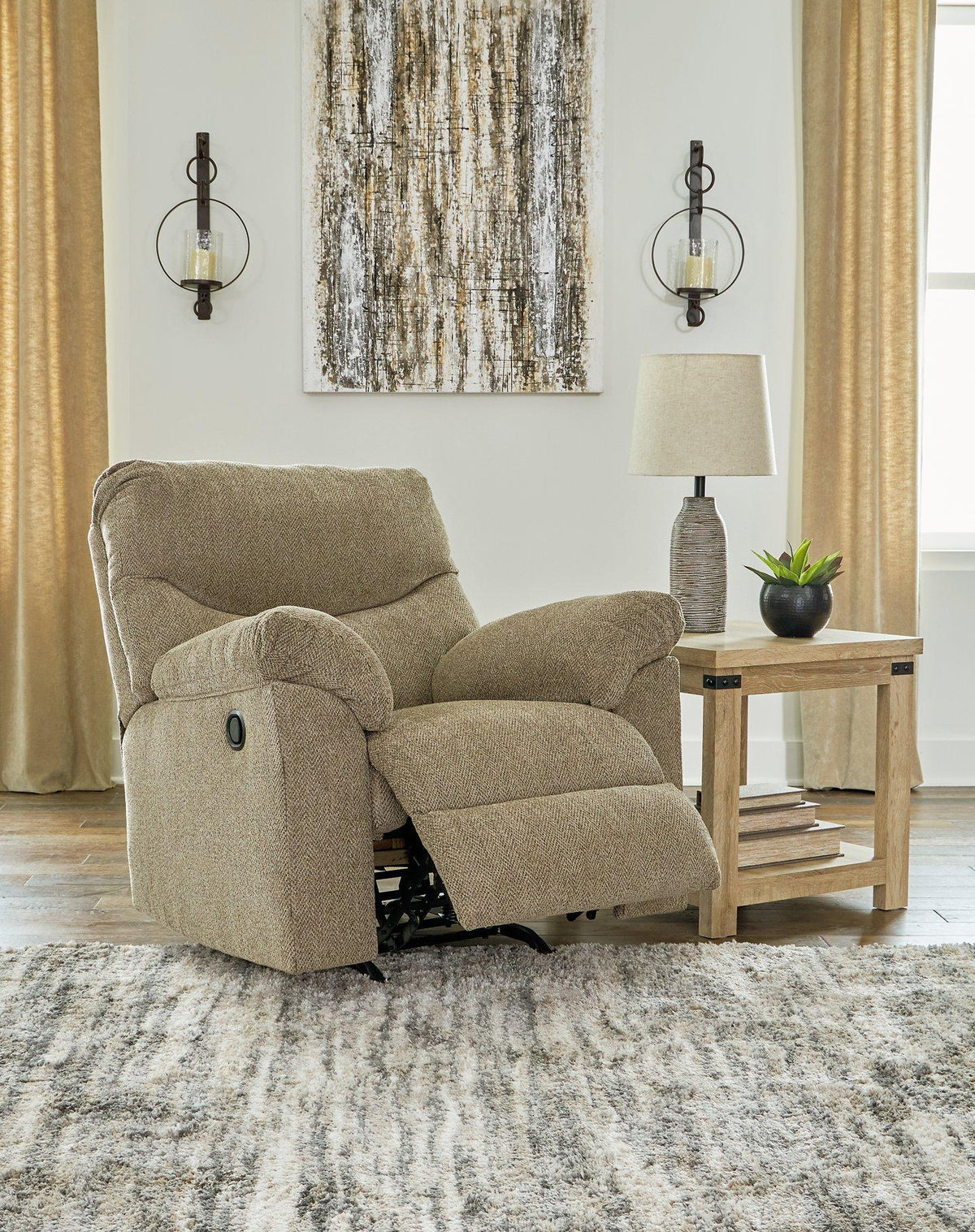 Ashley Furniture Alphons recliner in beige fabric with plush cushioning and wide armrests, perfect for comfortable lounging.