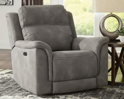 Ashley Furniture Next-Gen DuraPella power recliner in dark leather, showing closed position with plush cushioning and modern design.