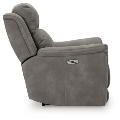 Ashley Furniture Next-Gen DuraPella power recliner with plush fabric and padded armrests, shown from a side view.