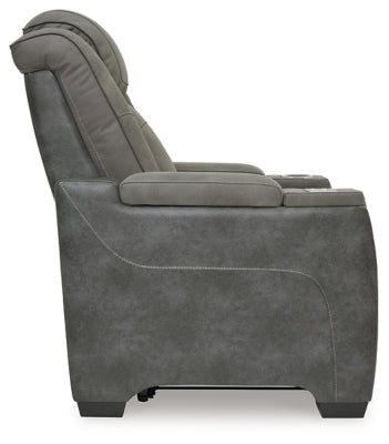 Ashley Furniture Next-Gen DuraPella power recliner with plush cushioning and dark leather upholstery, shown from the side.